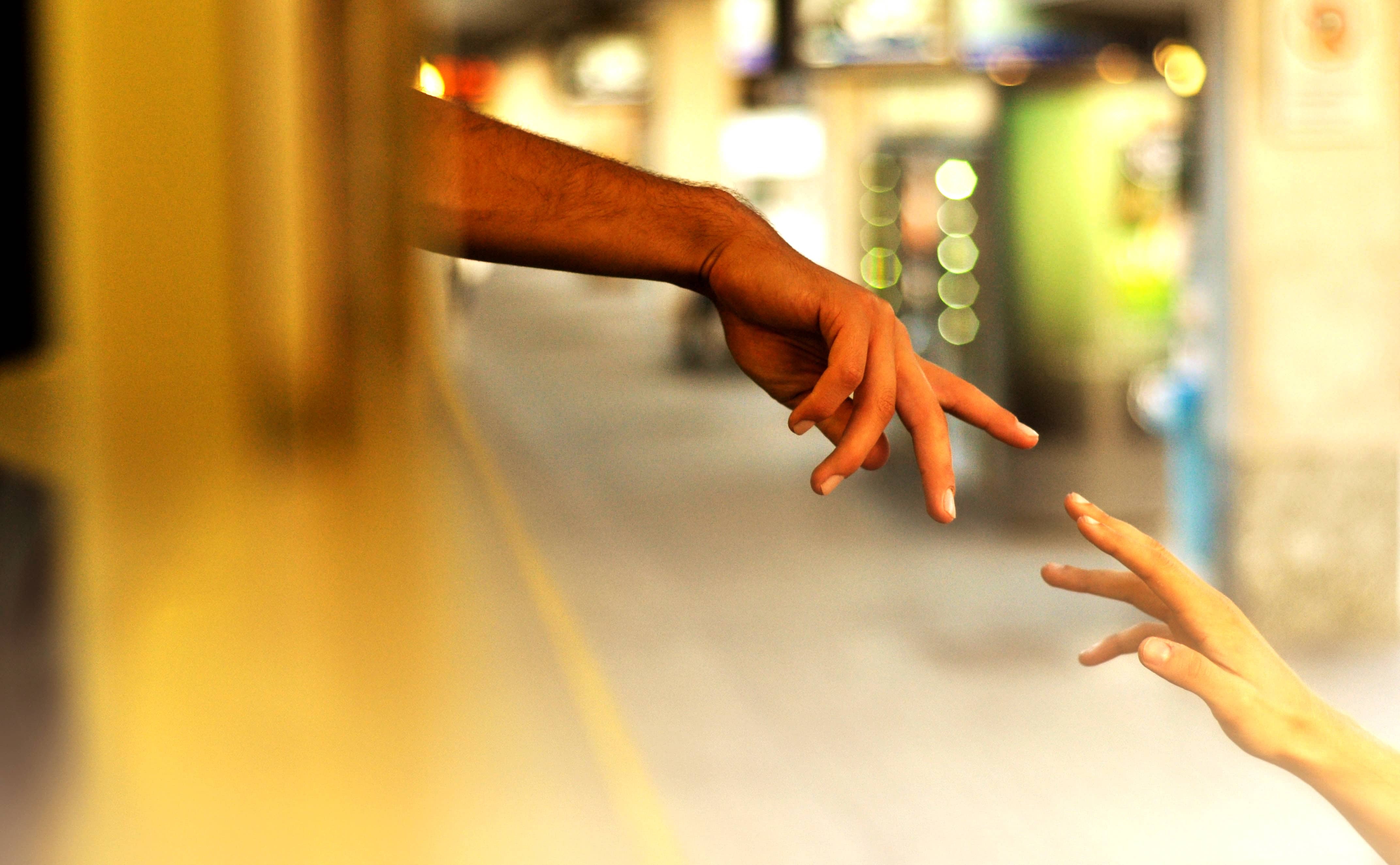 hands parting after saying goodbye on train