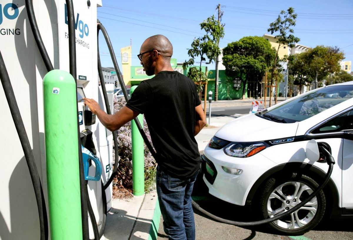 Michael McDaniel, 30, of Bakersfield, completes his purchase after charging his 2019 Chevy Bolt rental at a charging station at the corner of Bay and Columbus in San Francisco, Calif., on Thursday, September 26, 2019. It took nearly an hour to charge his vehicle at the total of $6. (Photo By Yalonda M. James/The San Francisco Chronicle via Getty Images)