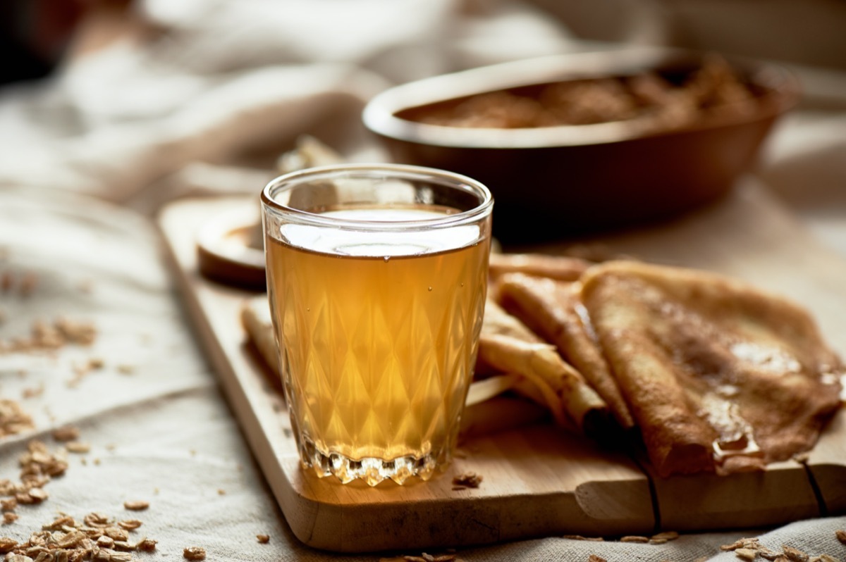 mead in clear glass on wooden board with pancakes