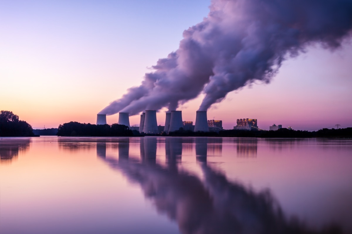 power Plant in the sunrise leaking fumes, carbon dioxide, earth day charities