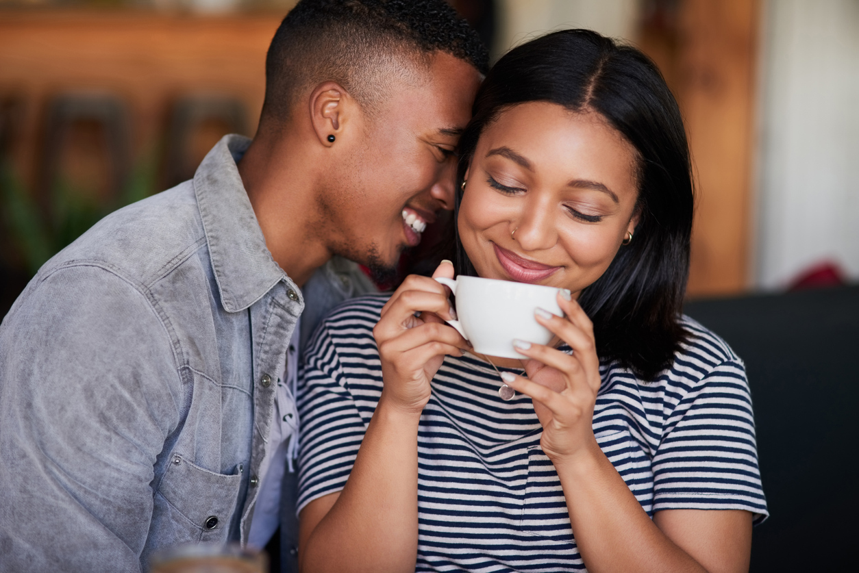 Shot of an affectionate young couple having coffee on a date in a cafe