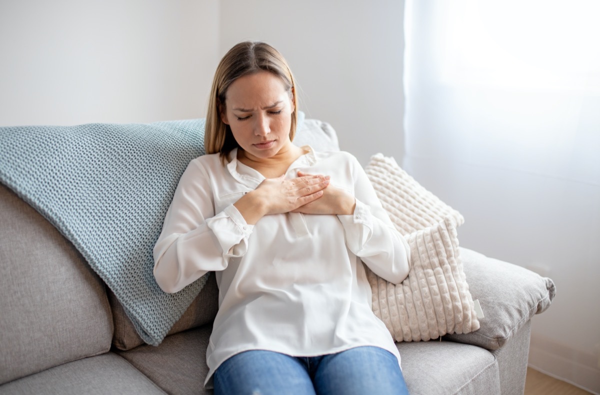 Woman having chest pain. respiratory system diseases