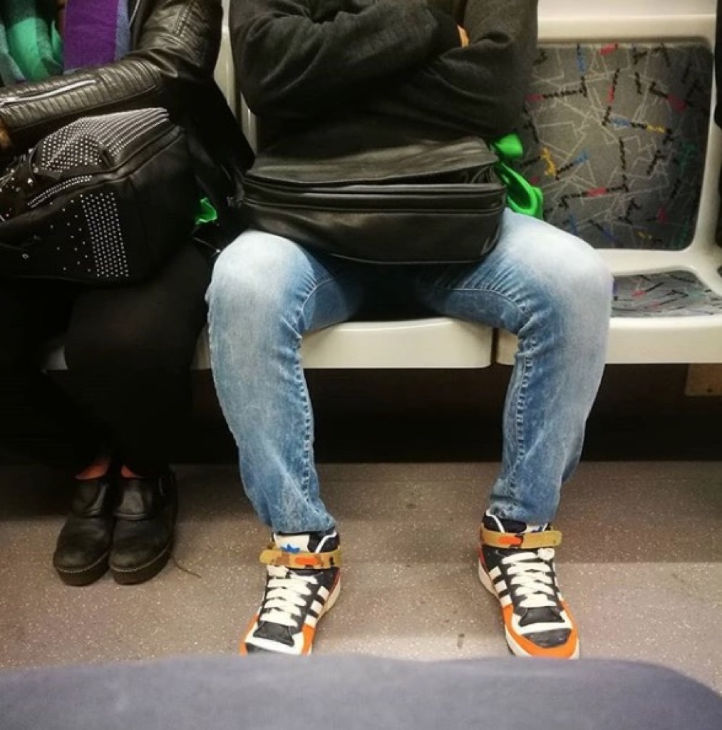 Man manspreading on the subway, city