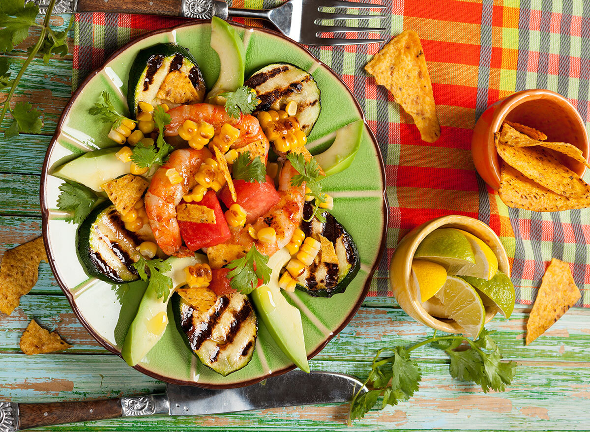 zucchini nachos on plate with shrimp corn chips lime lemon