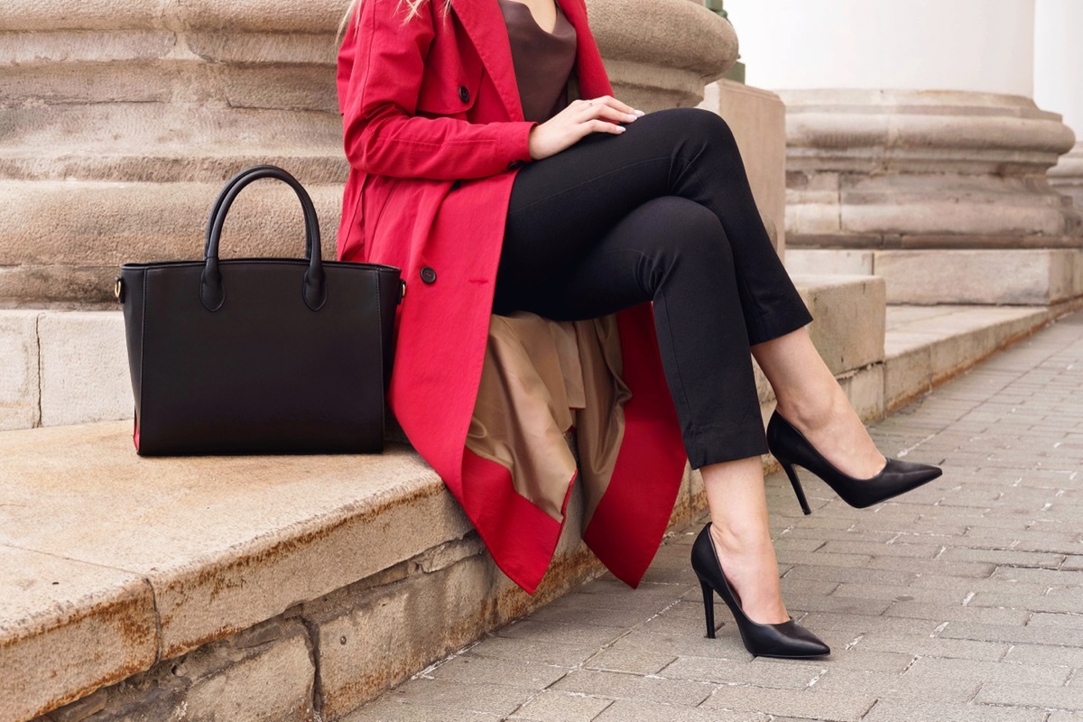 Woman Sitting Cross Legged on a Ledge