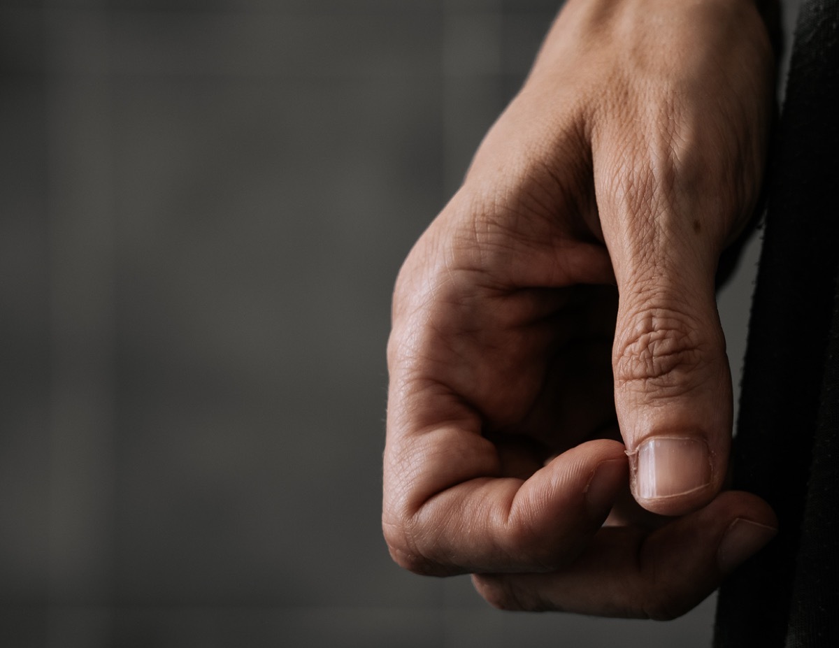 Woman nervously scratching a hangnail.