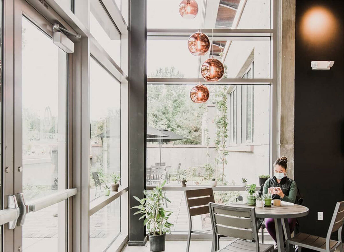 woman sitting at indoor dining cafe table