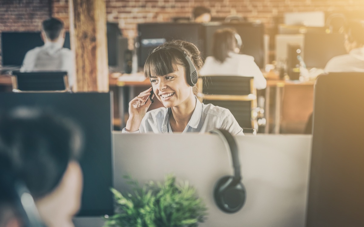 a telemarketer at work in front of a computer