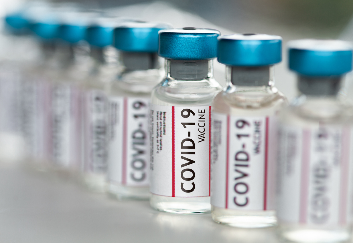 Vials of COVID-19 vaccine sitting in a row.