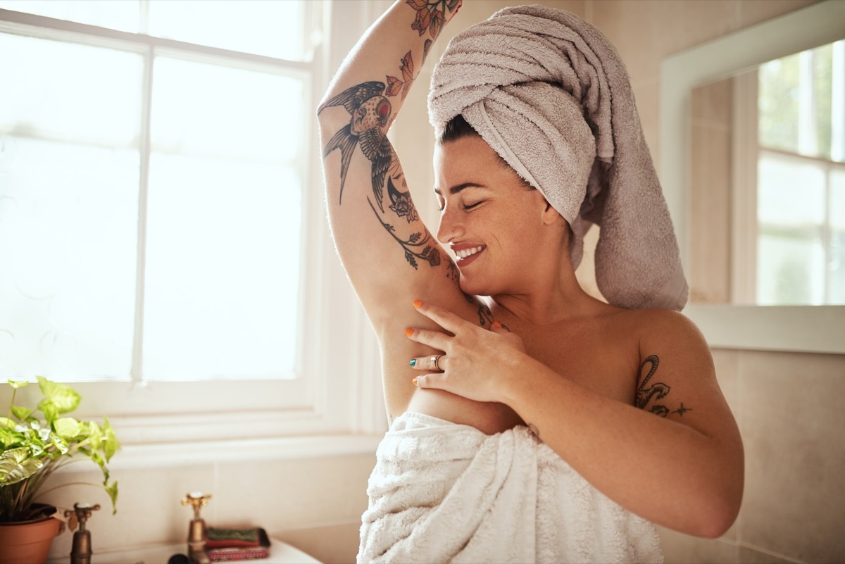 woman smelling herself after a shower