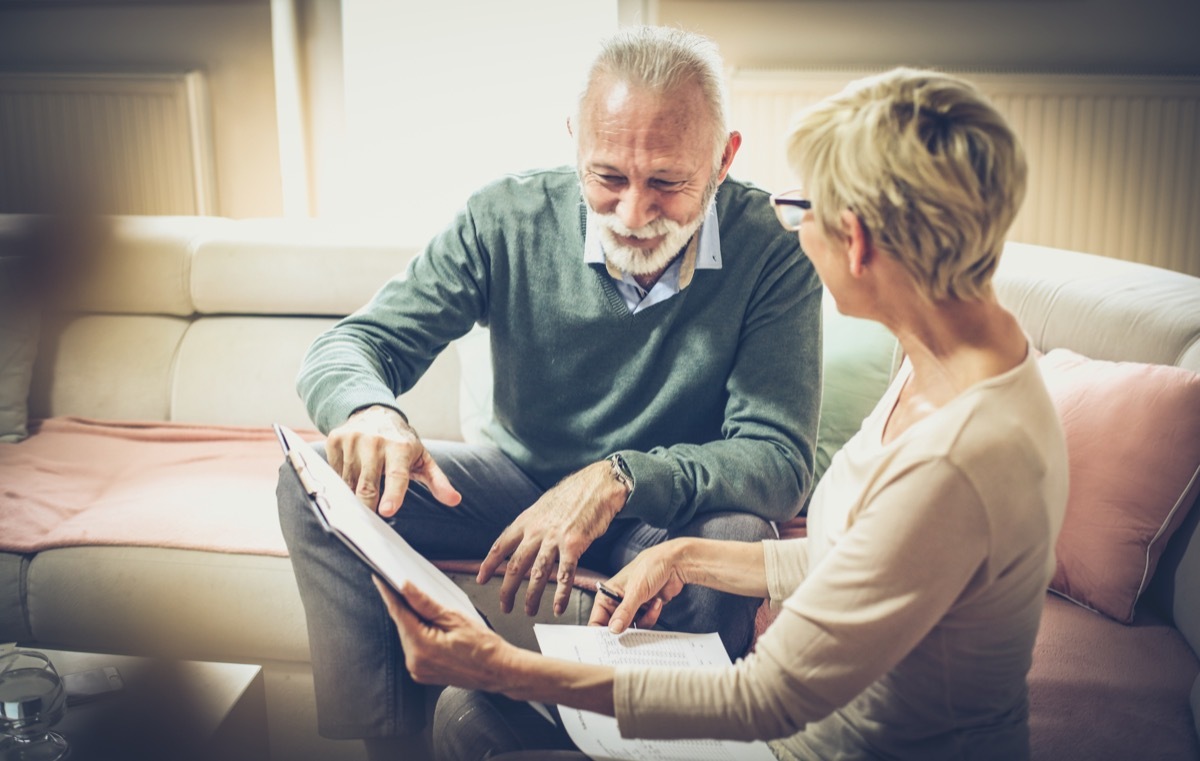 older white couple discussing paperwork