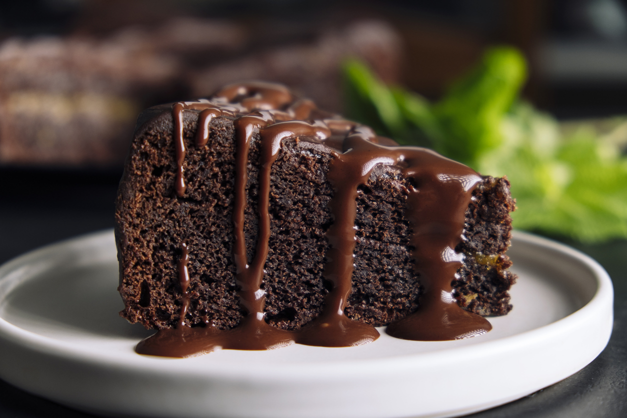 Slice of chocolate cake with glaze on a plate