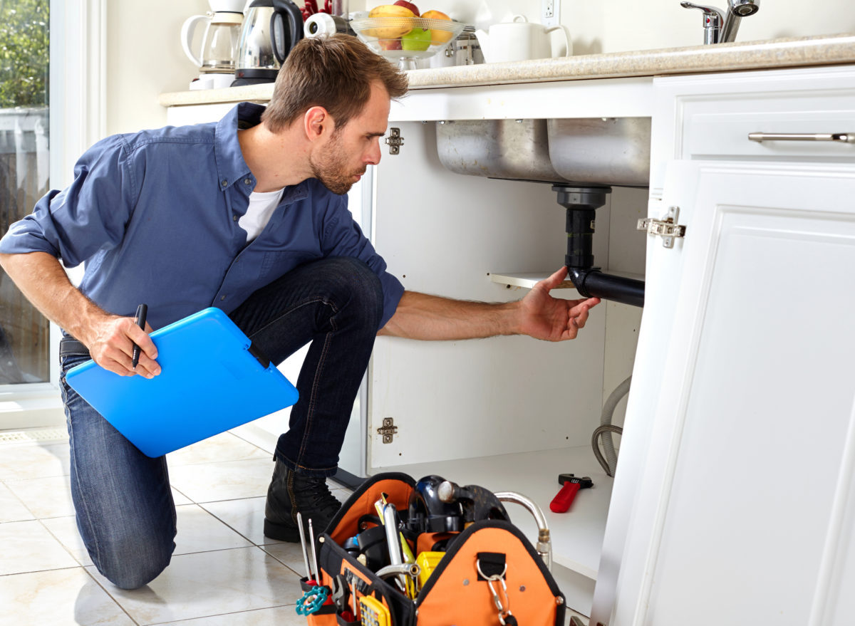 Plumber checking pipes