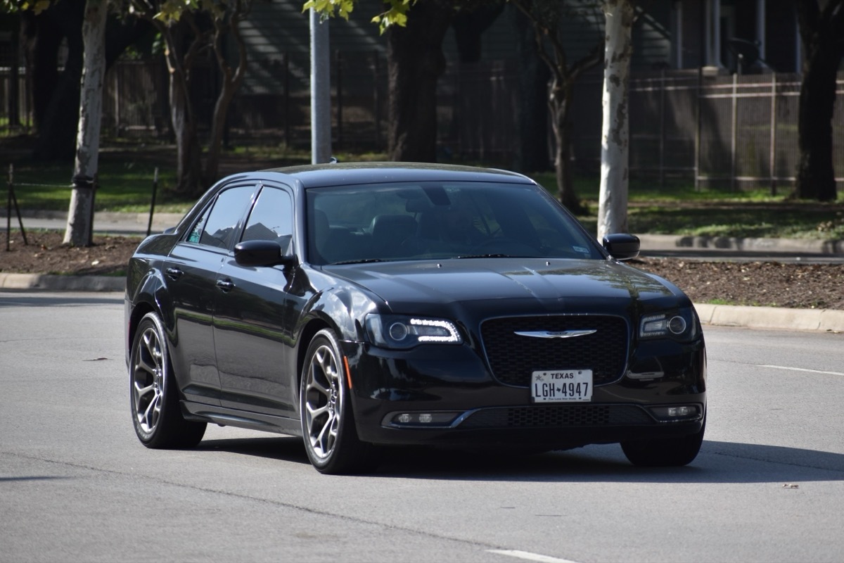 black chrysler 300 driver on the road