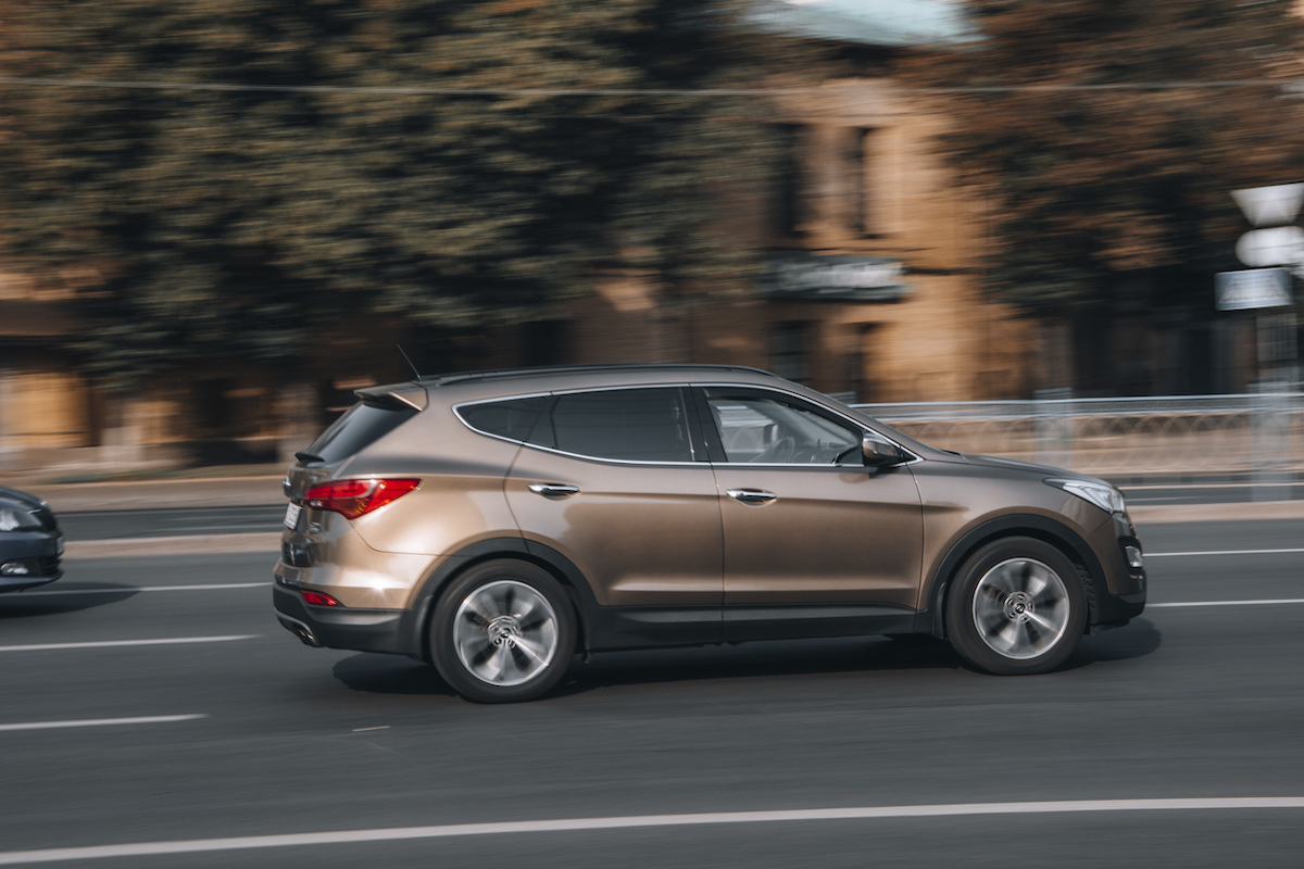 Brown Hyundai Santa Fe car moving on the street