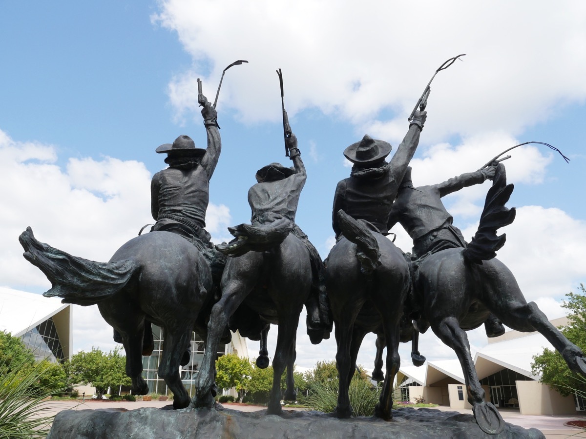 statue of cowboys on their horses