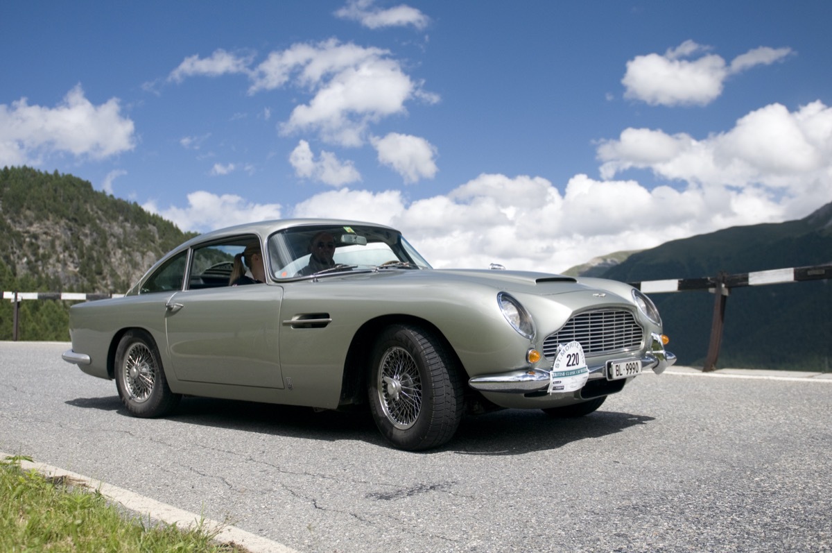 Two participants, a driver and his passenger from the British Classic Car Meeting in St. Moritz, riding in a Aston Martin DB5 manufactured in 1965, the Albula Pass down. The rally route of the 19th BCCM St. Moritz performs on Saturday 14 July 2012, from St. Moritz over the FlAelapass to Davos and Lenzerheide, and then over the Albula Pass BergAn and back to St. Moritz