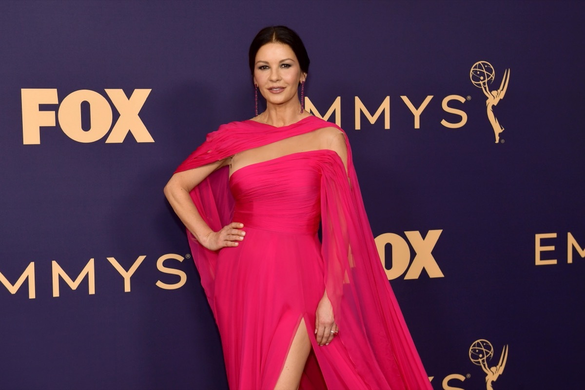 catherine zeta jones in pink cape dress on red carpet for grammys