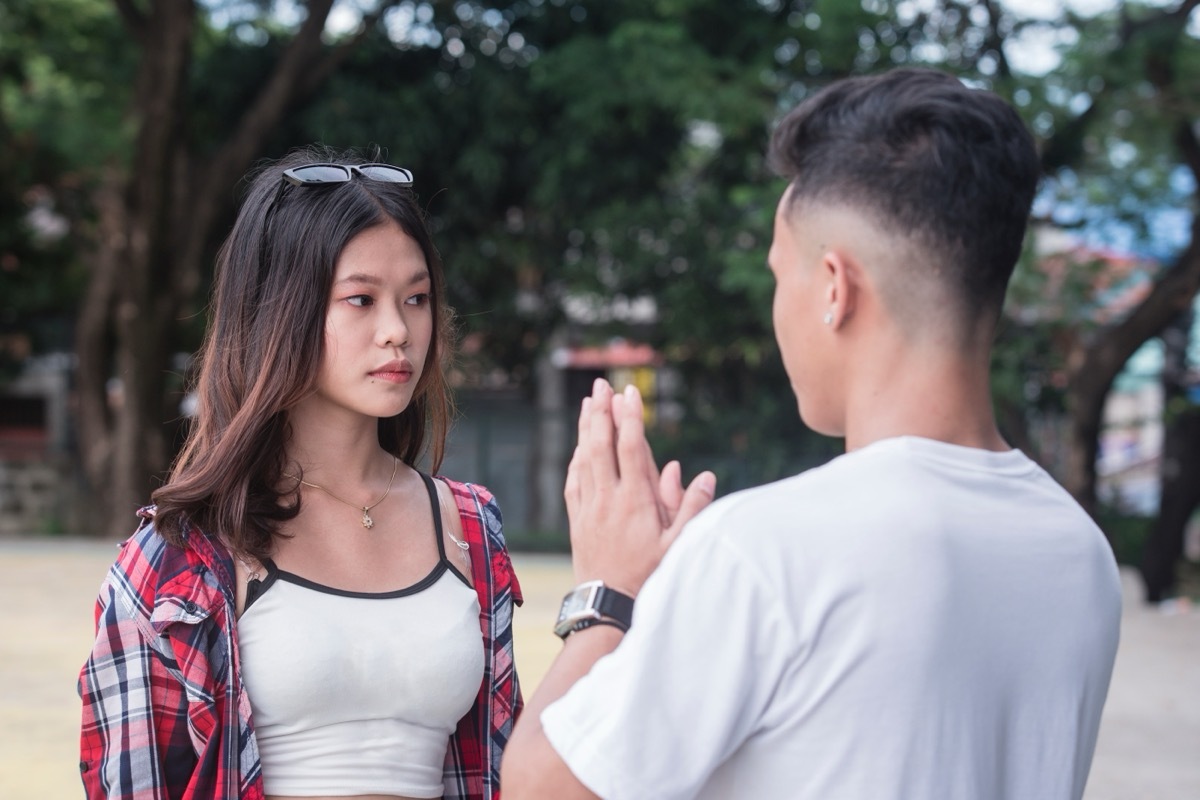 woman avoiding eye contact with man