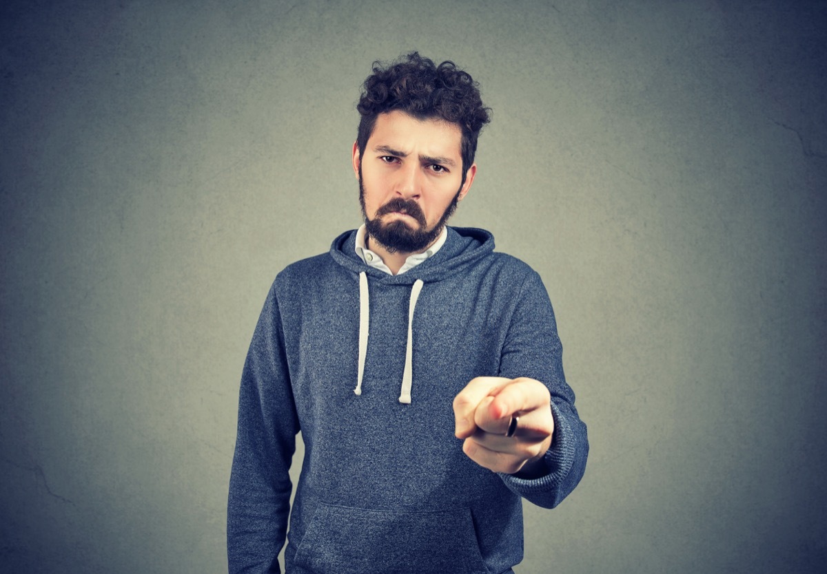 sad man with beard pointing at camera indicating guilt and blaming in anger