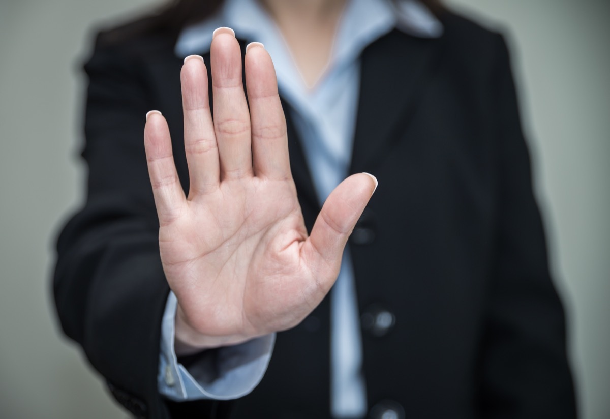 woman in suit showing her palm