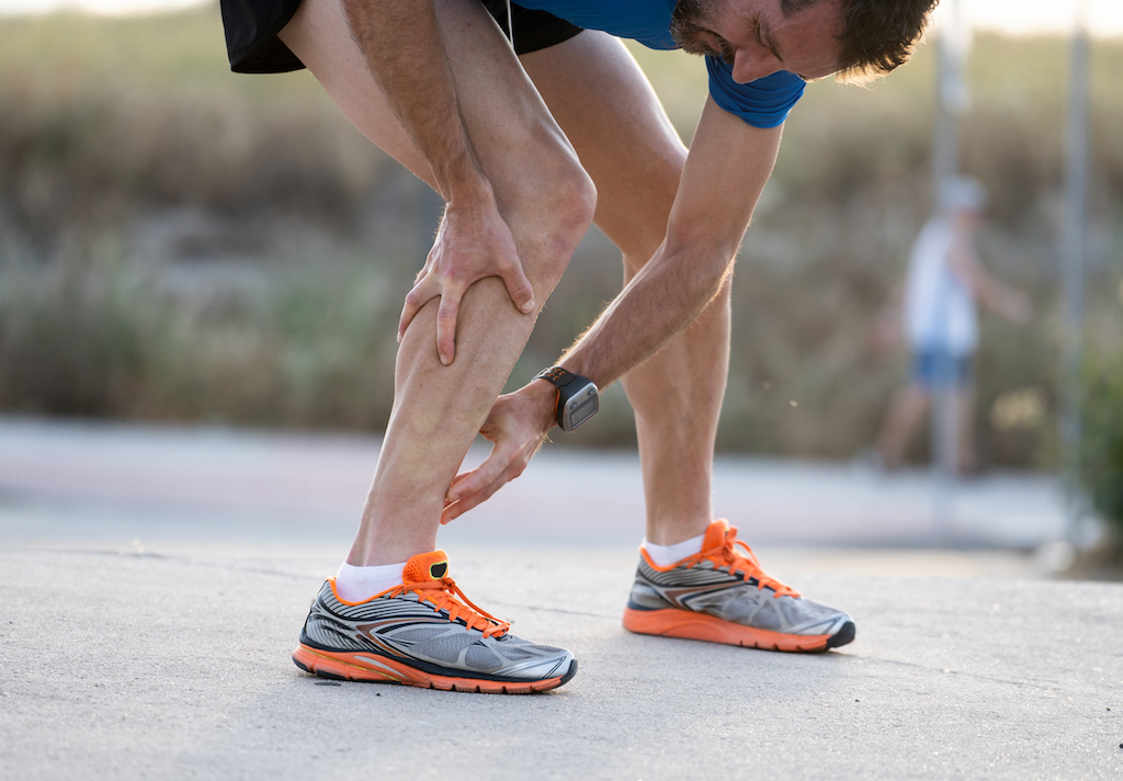 male runner suffering from a calf strain