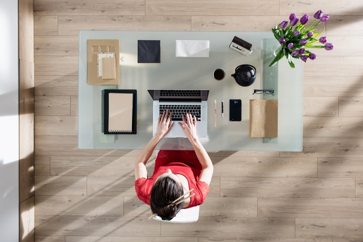 young white woman wfh at organized desk from home office