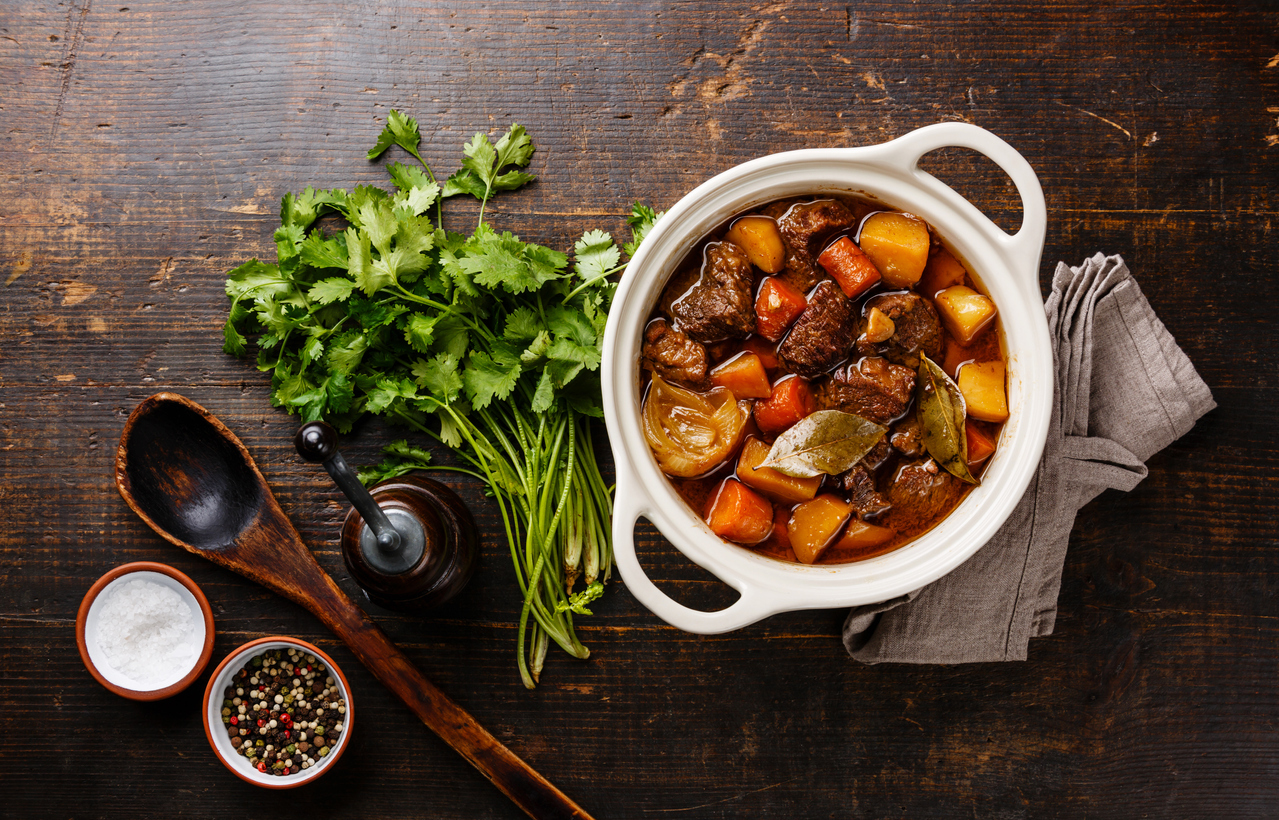 Beef meat stewed with potatoes, carrots and spices in ceramic pot