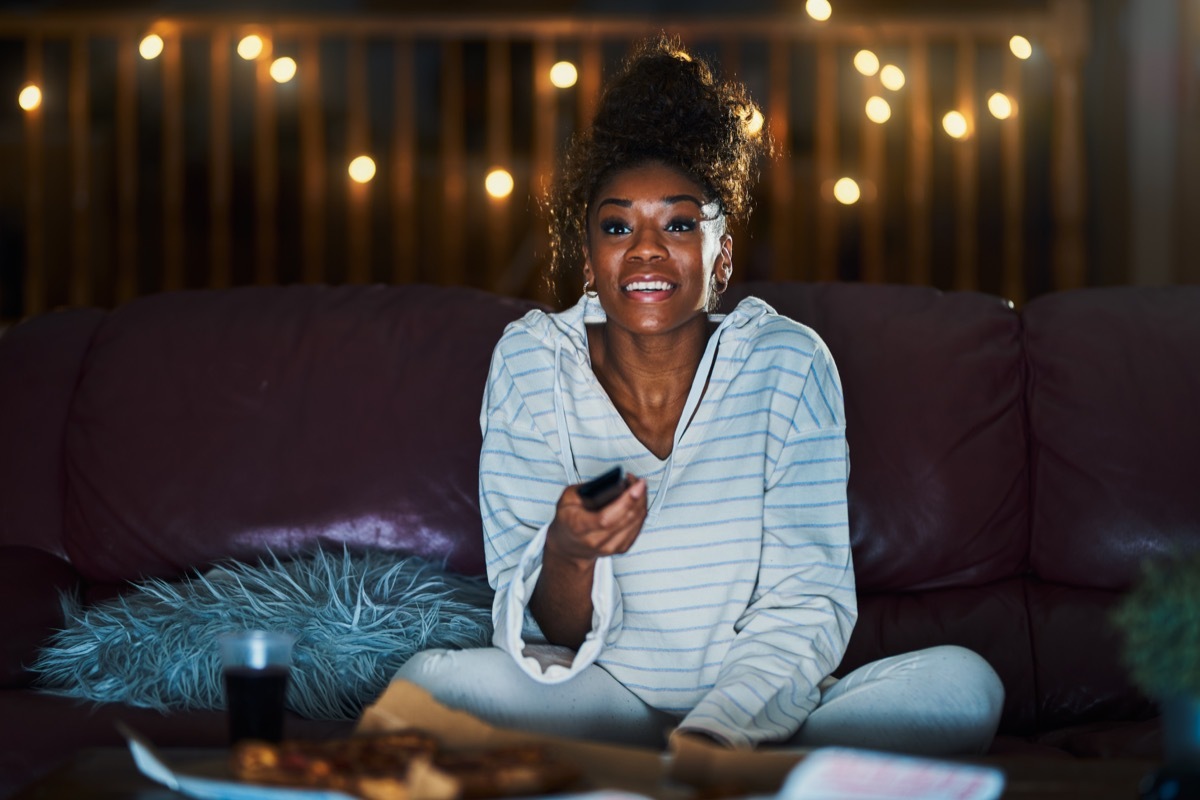 Woman watching tv alone