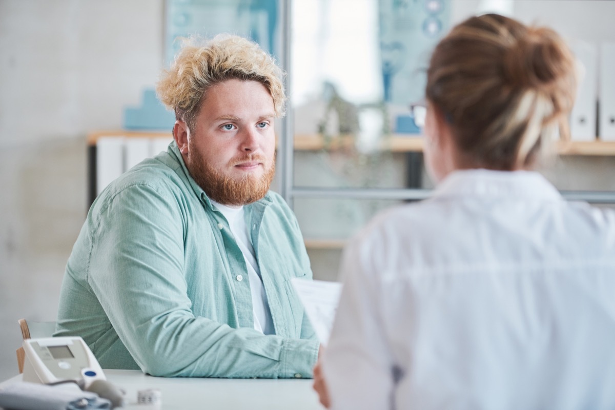 young man consulting with doctor about weight