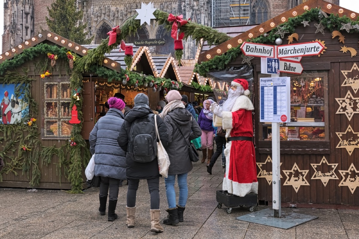 entrance to german christmas market features santa statue