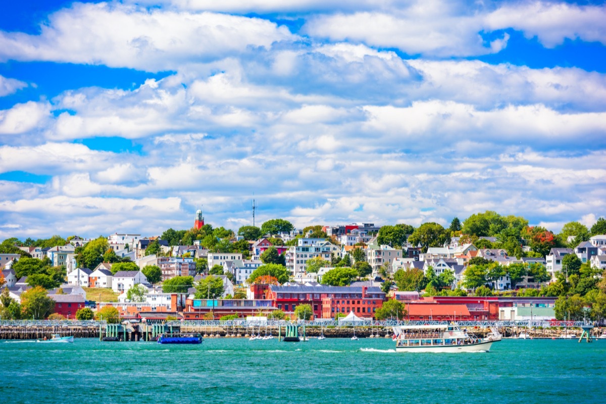 townhouses and building behind a lake in Portland, Maine