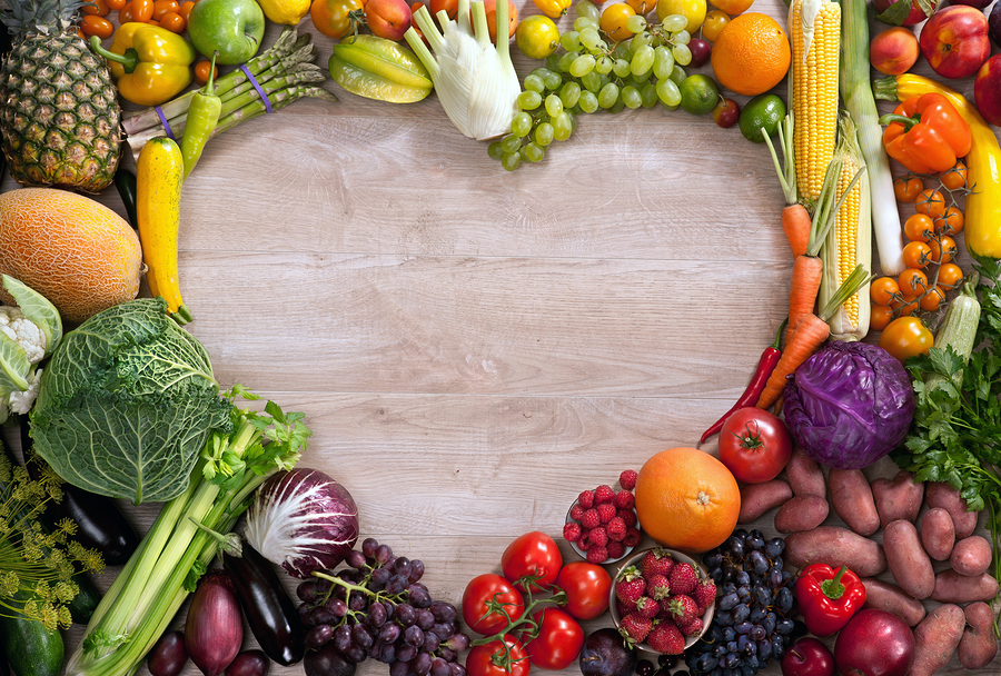 food photography of heart made from different fruits and vegetables on wooden table