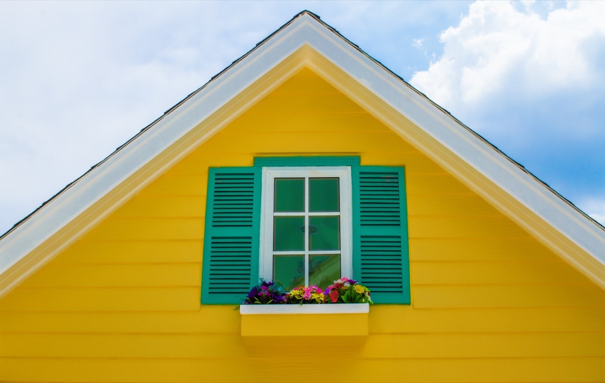 yellow house with green shutters