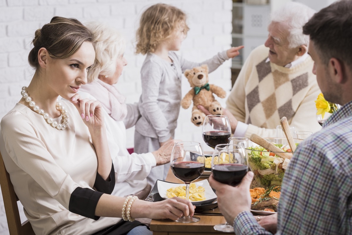 Shot of a family dinner with a young couple in the foreground