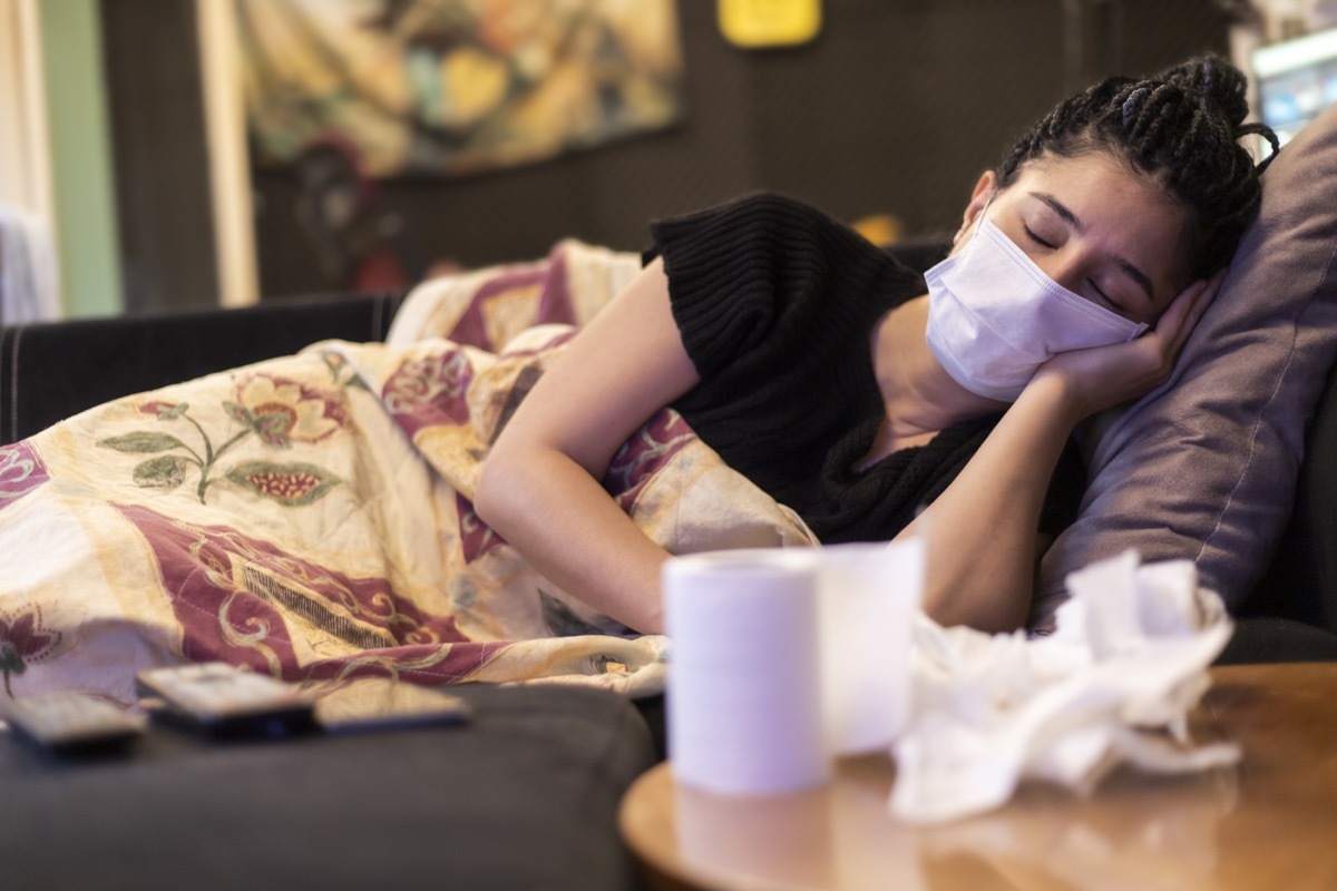 One woman infected with virus and sick. sleeping in home, using face mask, handkerchief and toilet paper on table