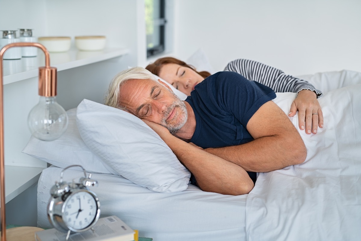 Older couple sleeping in bed