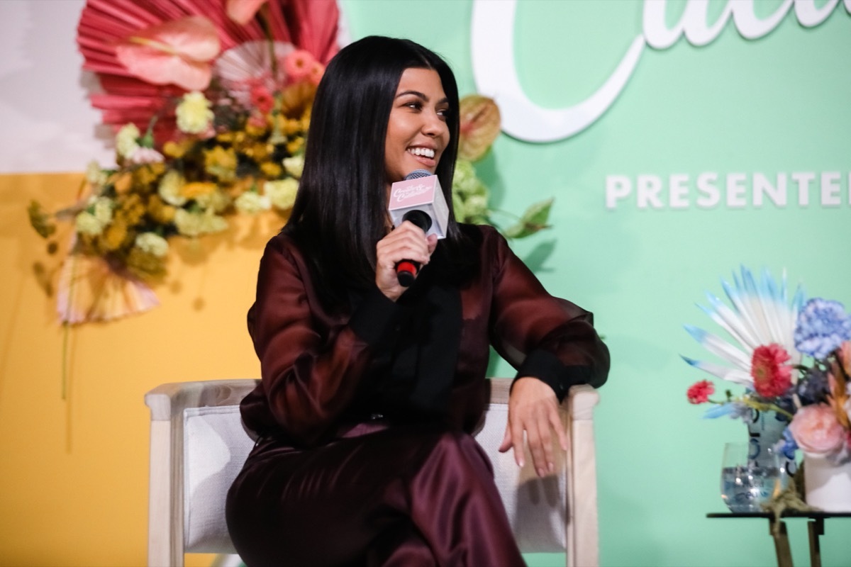 kourtney kardashian in purple silk jumpsuit