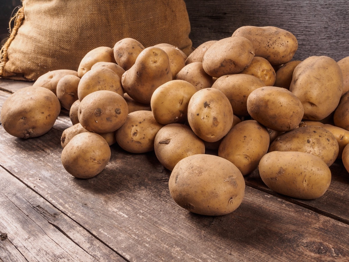 potatoes on wooden surface