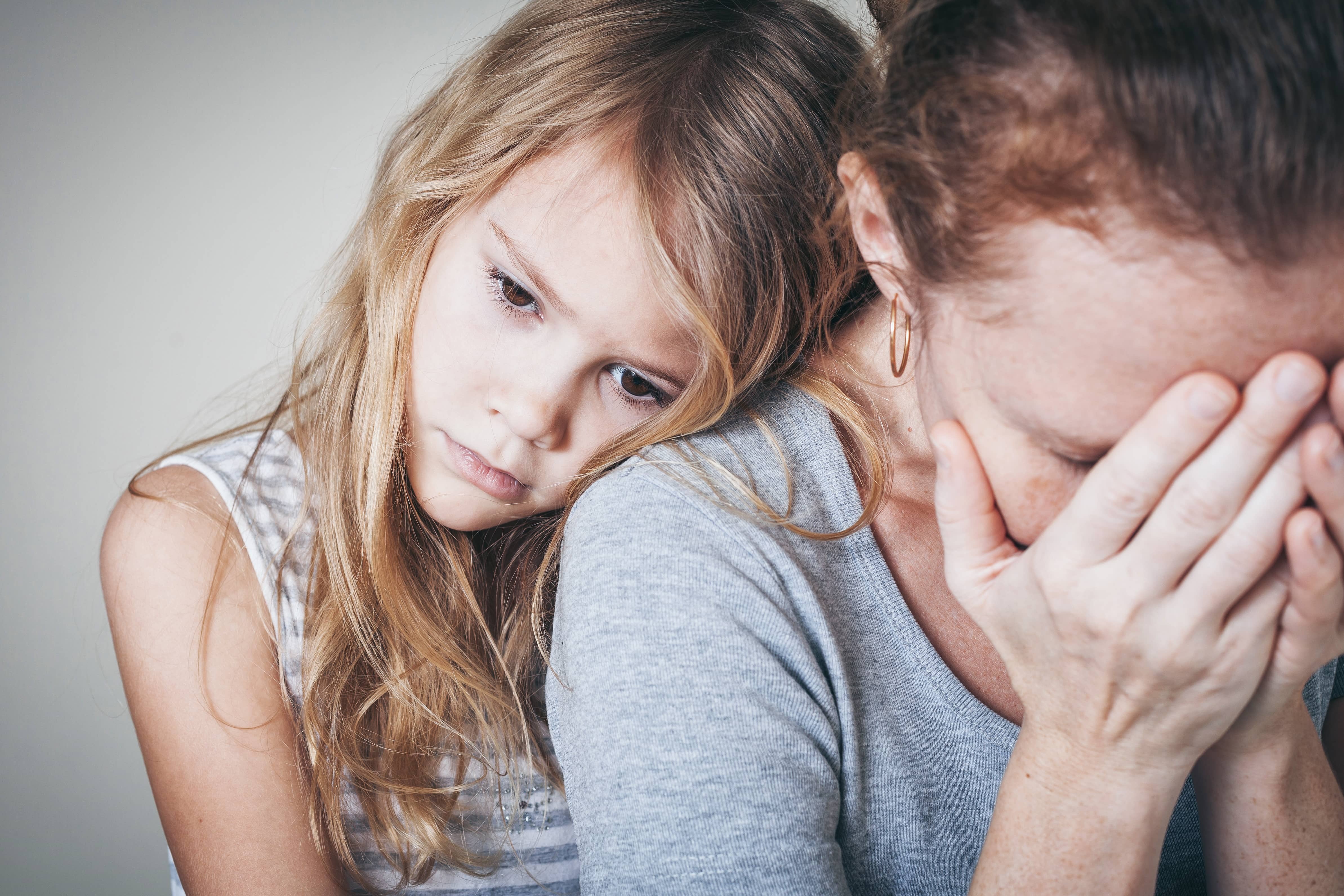 little girl comforting her mother