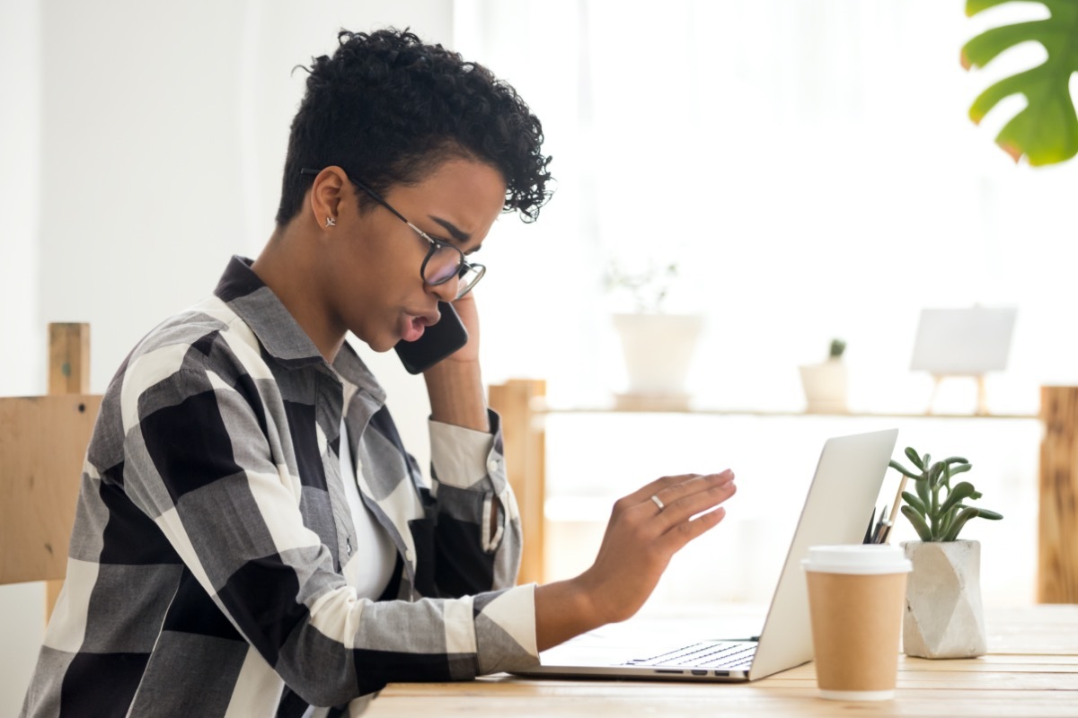 Confused young black woman on phone