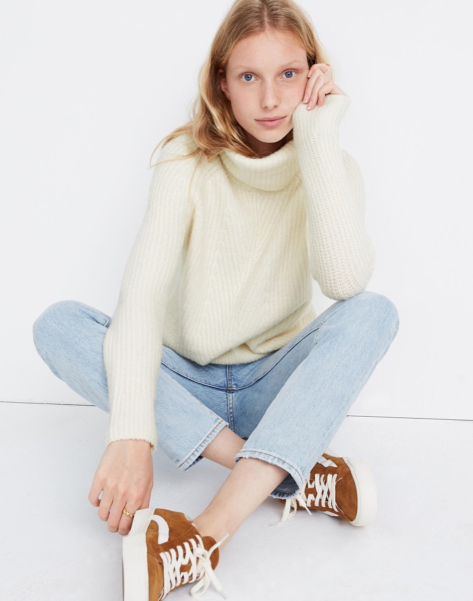 Woman wearing white turtleneck sweater