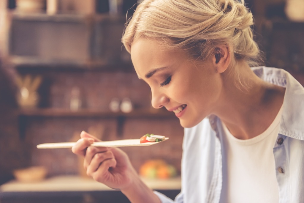 woman tasting food, ways your body changes after 40