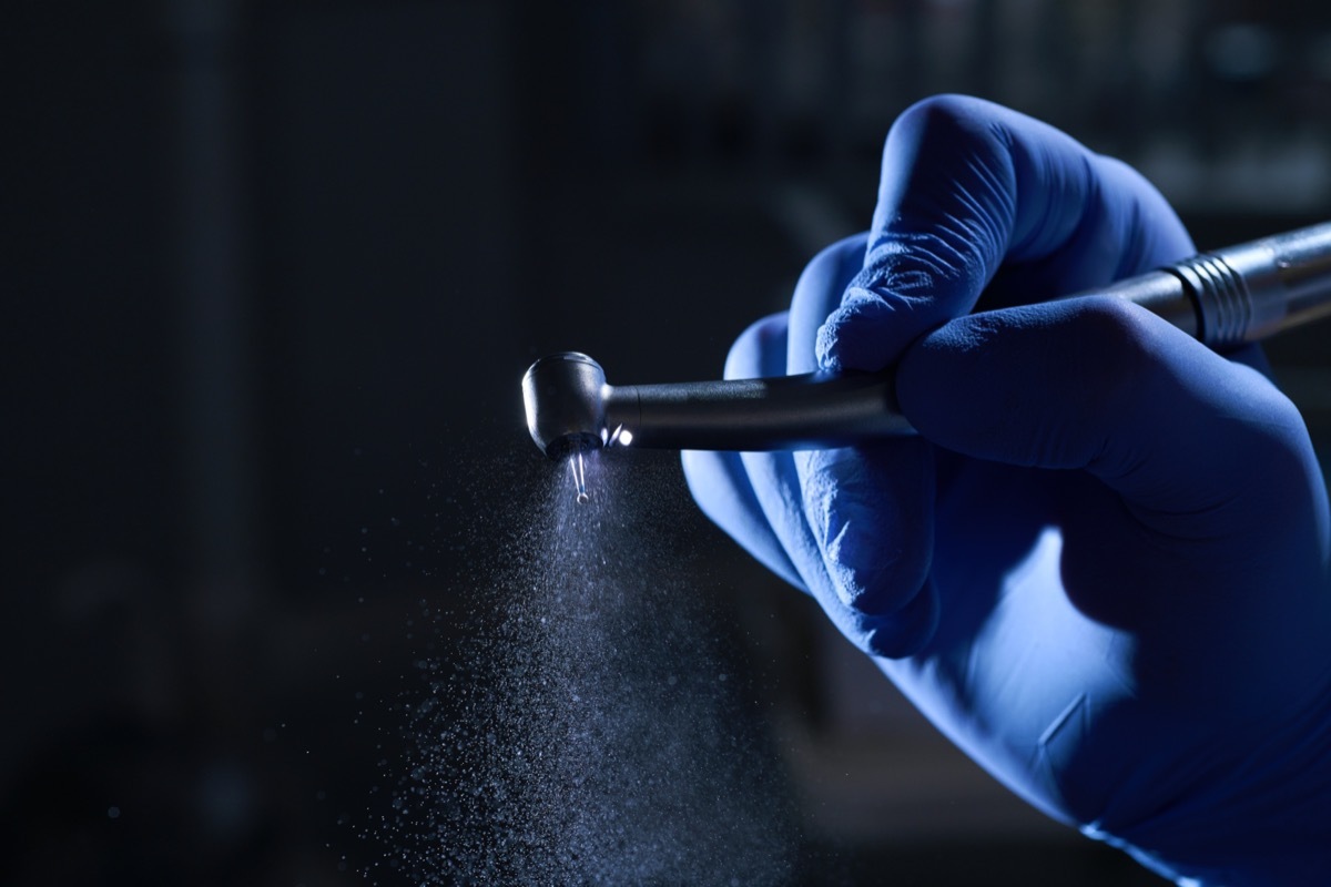 Close up on a dentist holding a drill