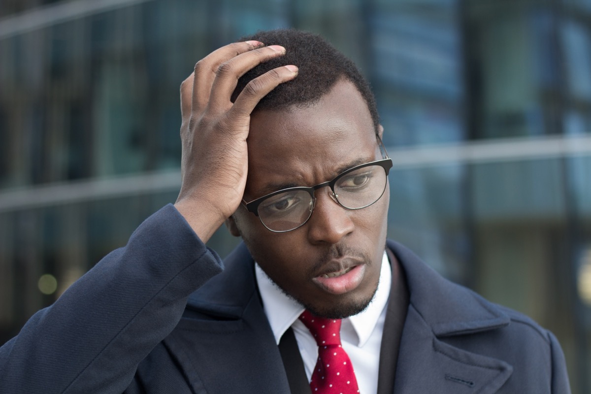 Man scratching his head confused