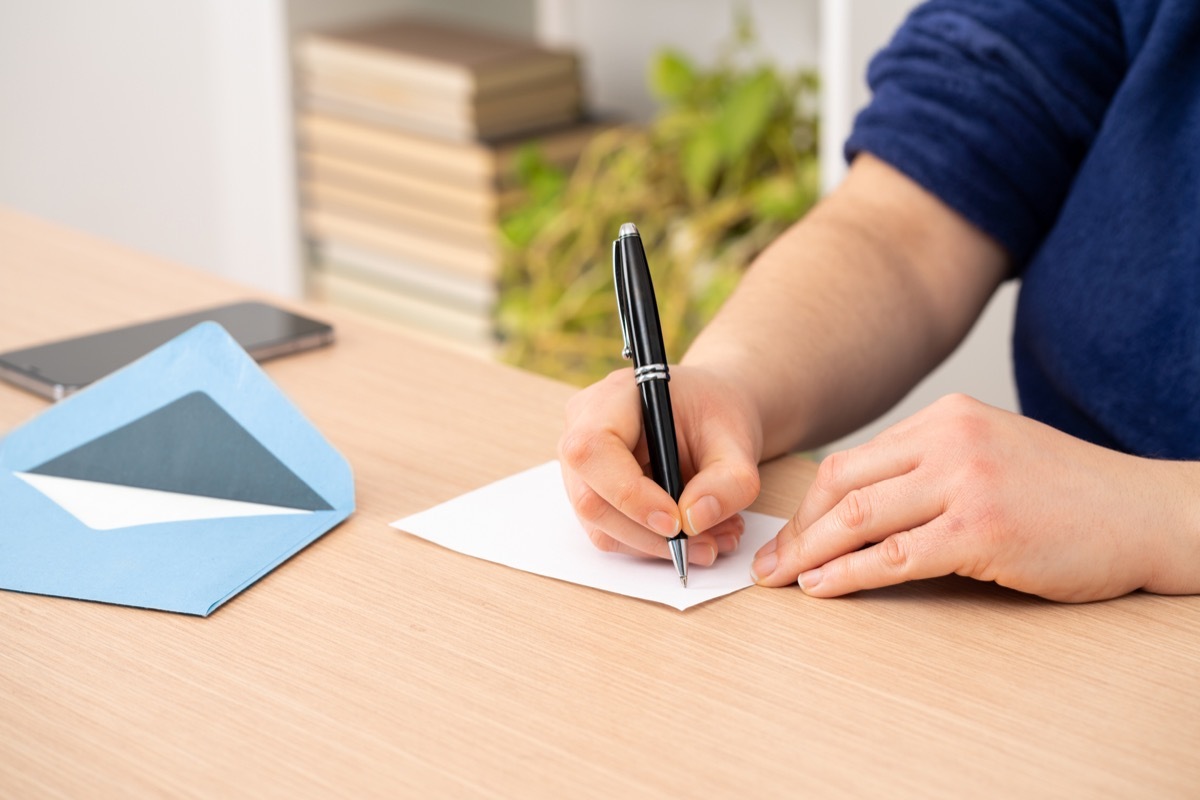 man filling out rsvp card