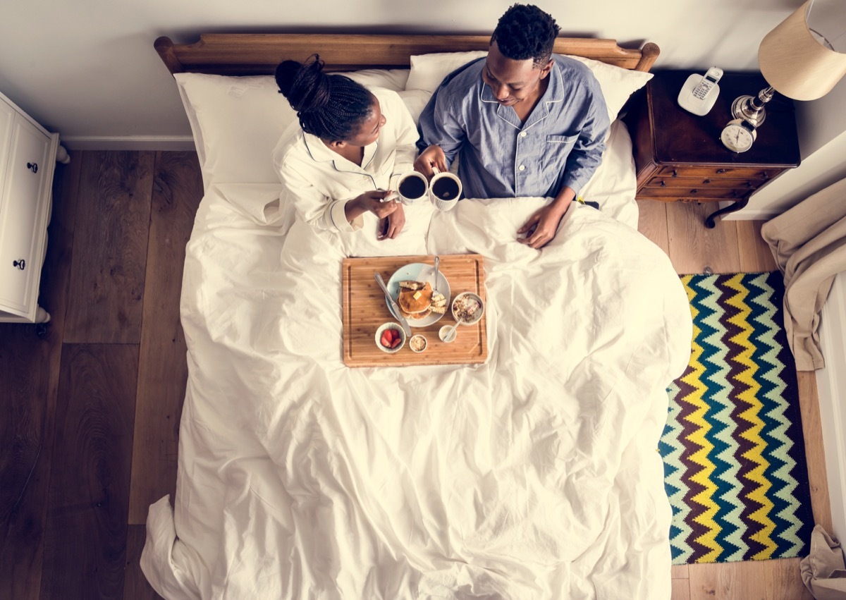 Couple having breakfast in bed