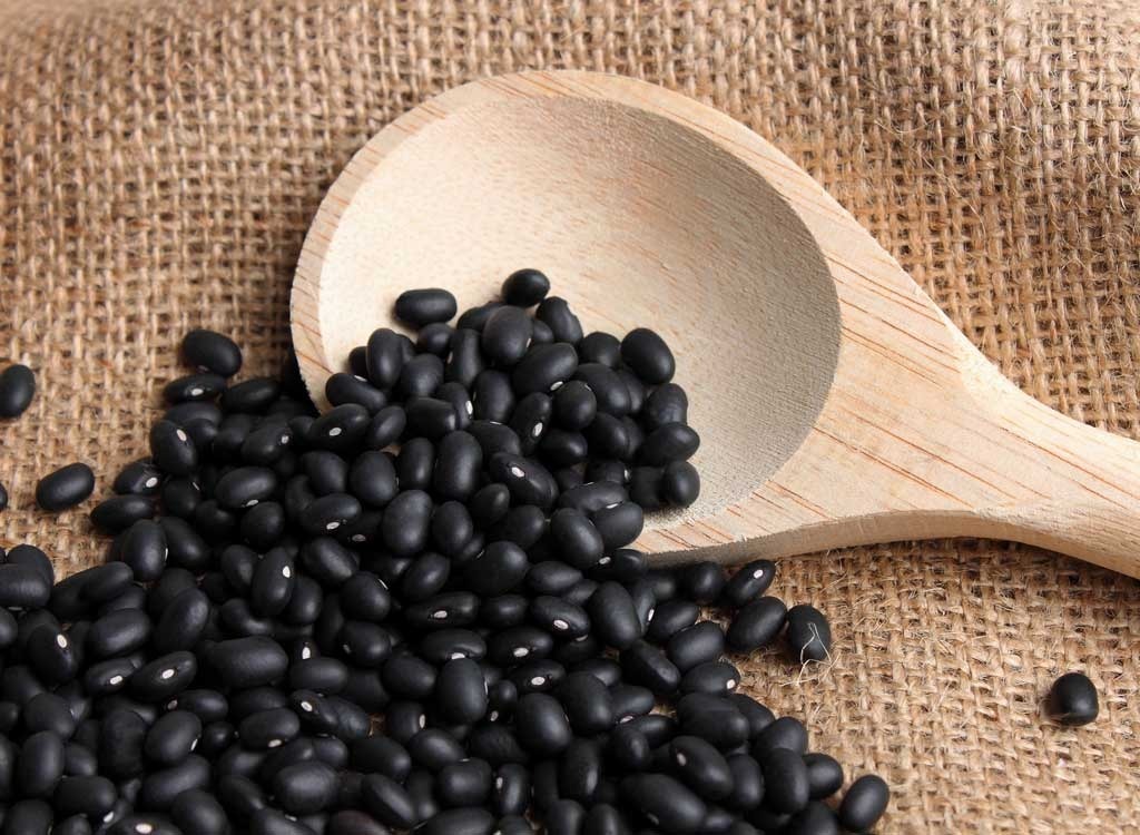 black beans with wooden spoon