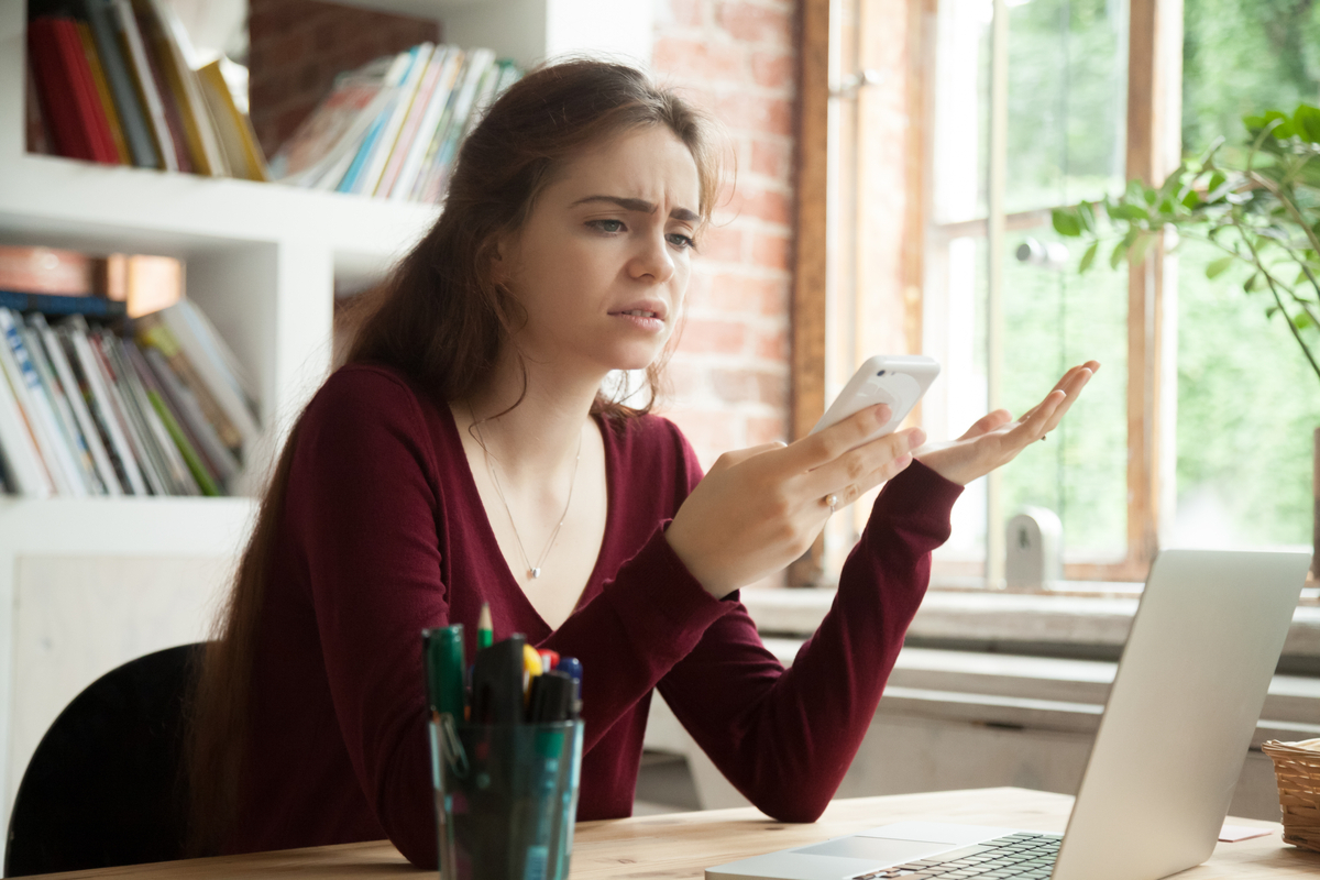 Woman looking confused at her phone