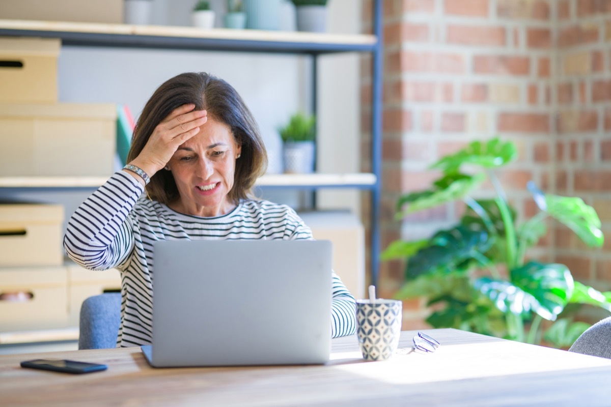 Woman on a laptop looking stressed and angry